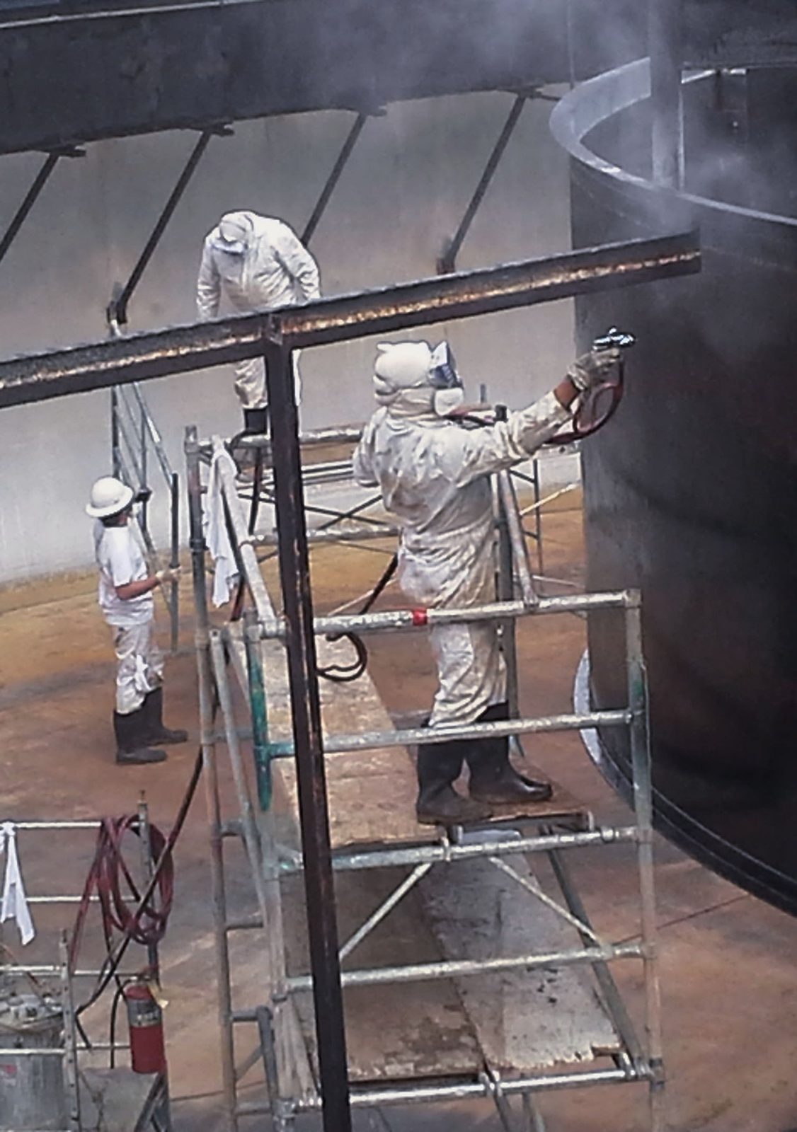 Crew applying industrial coating